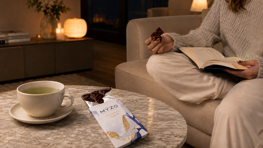 Girl winding down reading a book and having chocolate