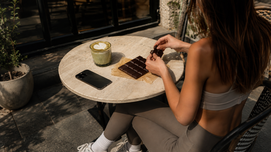 Girl in cafe eating chocolate with matcha