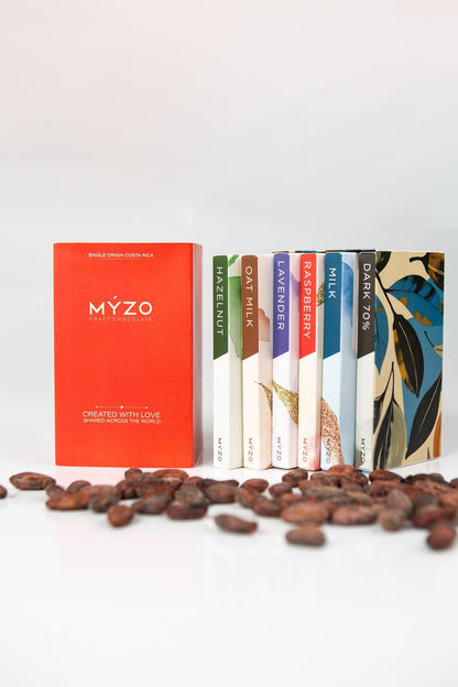 Top-down view of MYZO 6-Bar Chocolate Gift Box revealing 70% Dark, 48% Milk, Oat Milk, Hazelnut, Raspberry, and Lavender bars