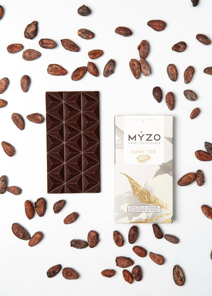 Flat lay of MYZO 70% Dark Chocolate bar with packaging and Costa Rican cacao