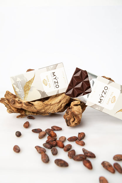 MYZO 70% Dark Chocolate bar surrounded by raw Costa Rican Matina cacao beans