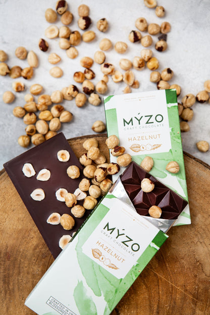 MYZO Hazelnut Dark Chocolate bar styled with whole hazelnuts and Costa Rican Matina cacao