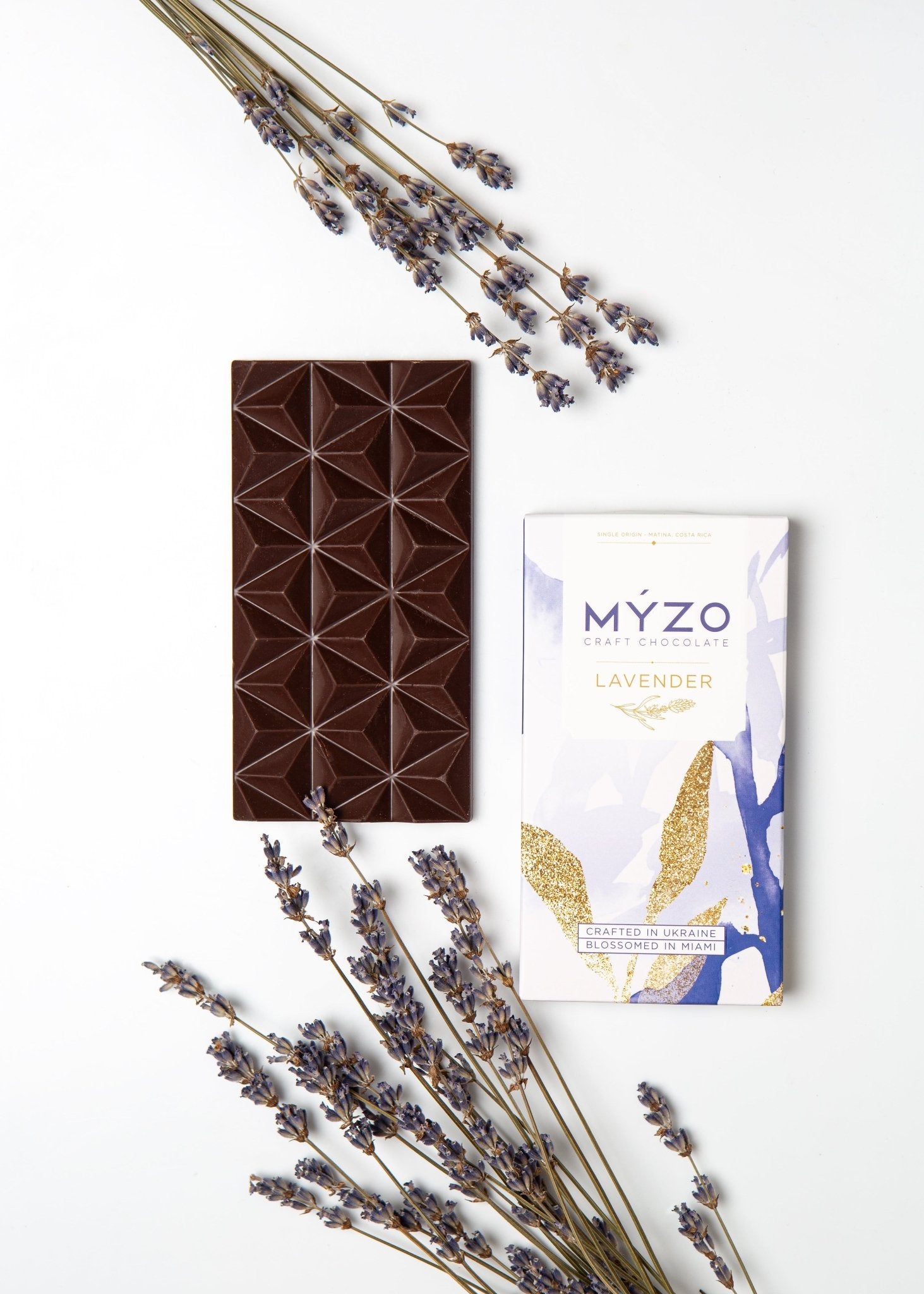Flat lay of MYZO Lavender Dark Chocolate bar with packaging and dried lavender
