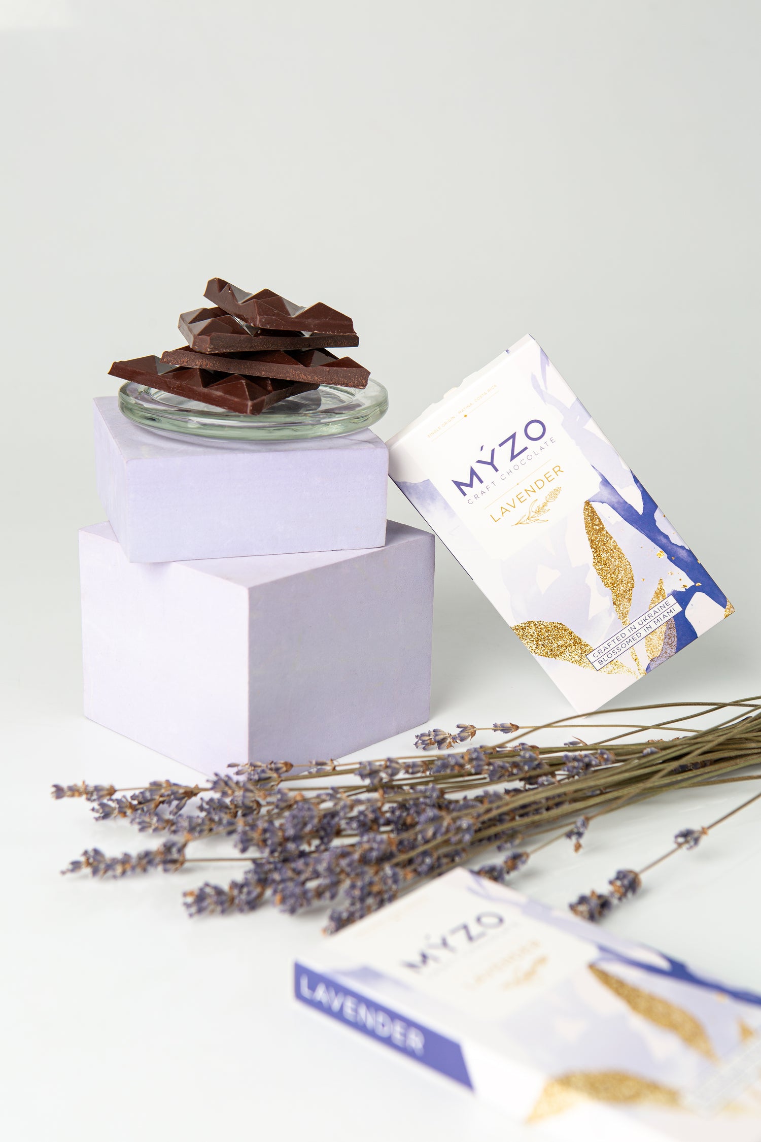 Jar of chocolate with lavender flowers and MYZO packaging on a white background