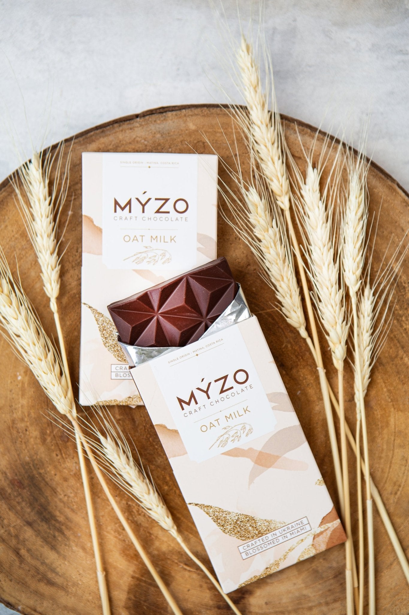 MYZO 48% Oat Milk Chocolate styled with oat grains and single-origin Matina cacao