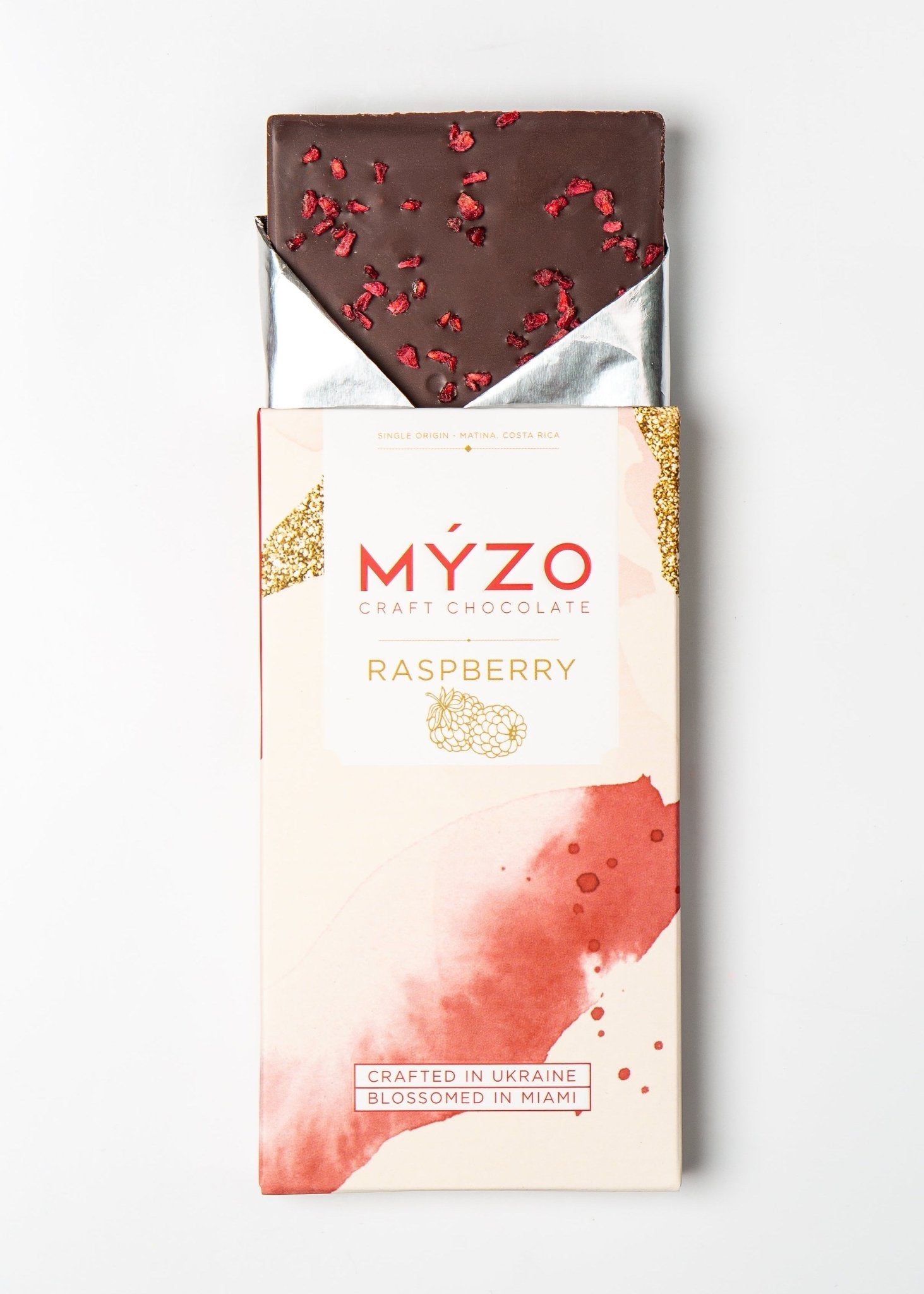 MYZO 70% Raspberry Dark Chocolate bar unwrapped with freeze-dried raspberry pieces visible